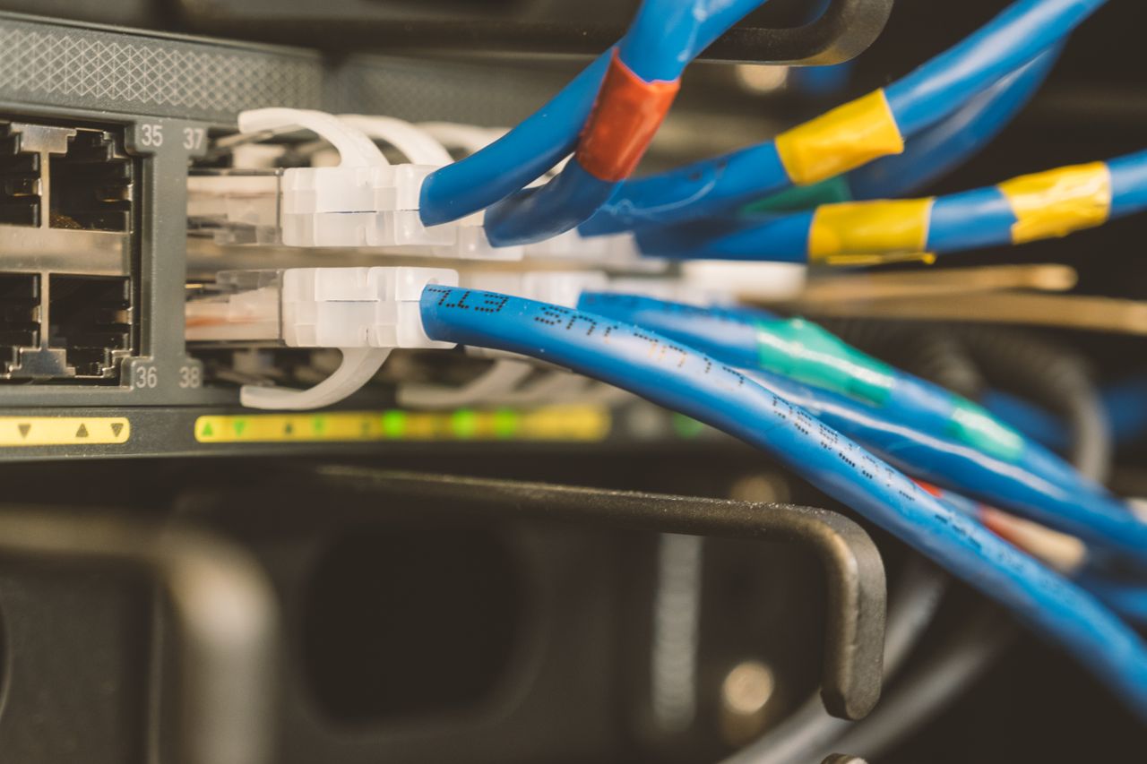 about-03 Network switch and blue ethernet cable with white tips connected to system for maintenance