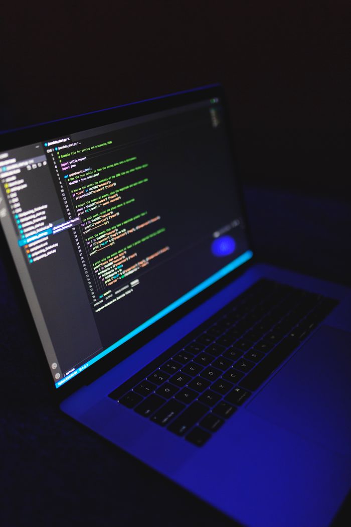The Art of Drawing Readers In: Your attractive post title goes here A laptop showcasing colorful code in a dark environment, ideal for tech or programming content.